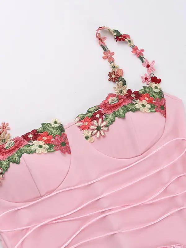 Close-up of floral embroidery on pink dress