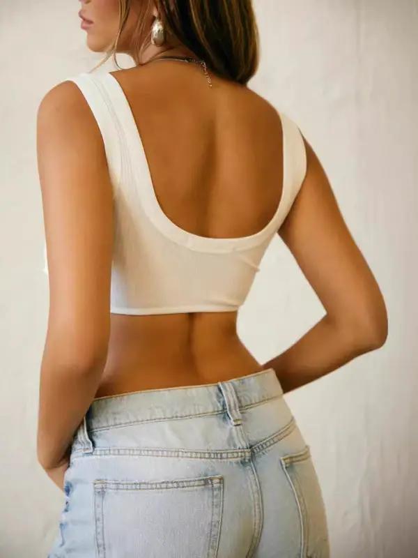 Back view of white backless camisole with jeans