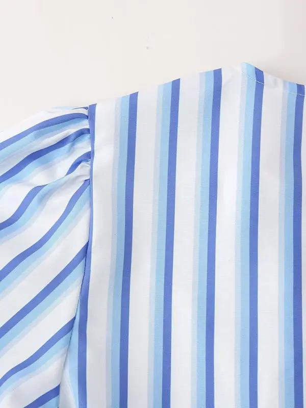 Close-up of blue striped puff sleeve detail