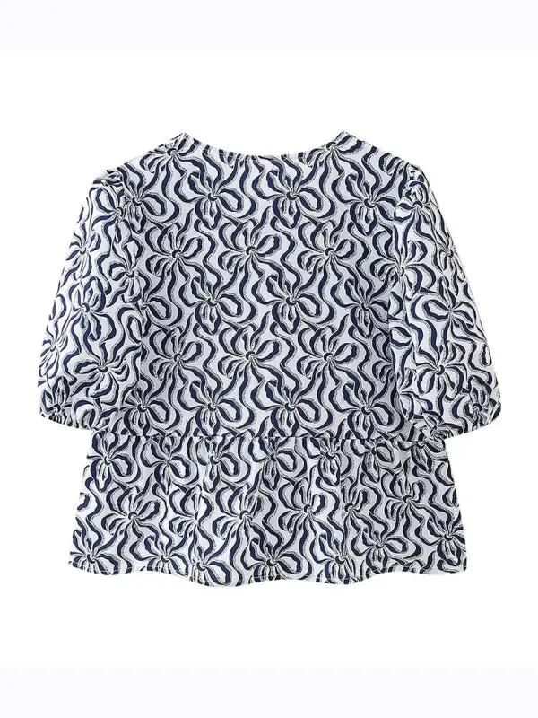Navy patterned puff sleeve lace-up top, back view