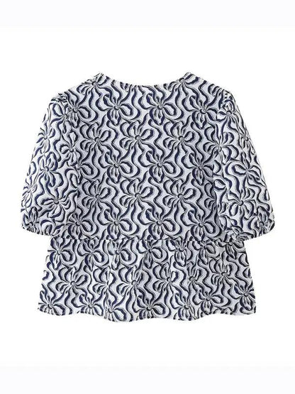 Navy patterned puff sleeve lace-up top, back view