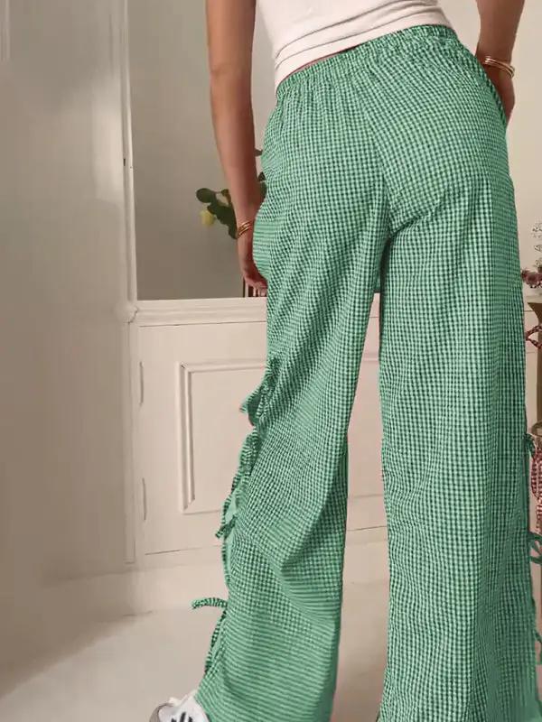 Back view of green plaid strappy trousers