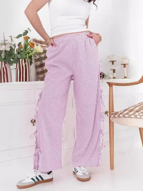 Woman wearing purple plaid strappy trousers