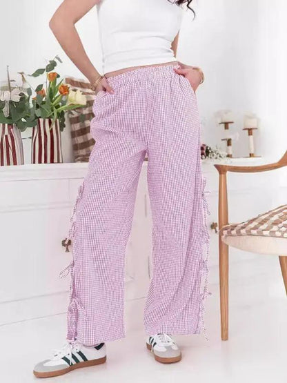Woman wearing purple plaid strappy trousers