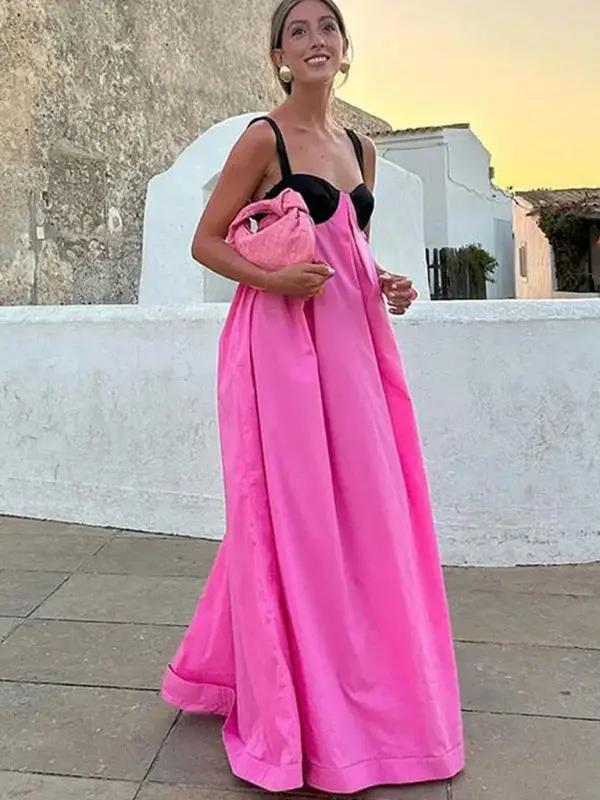 Woman wearing pink and black spliced backless dress