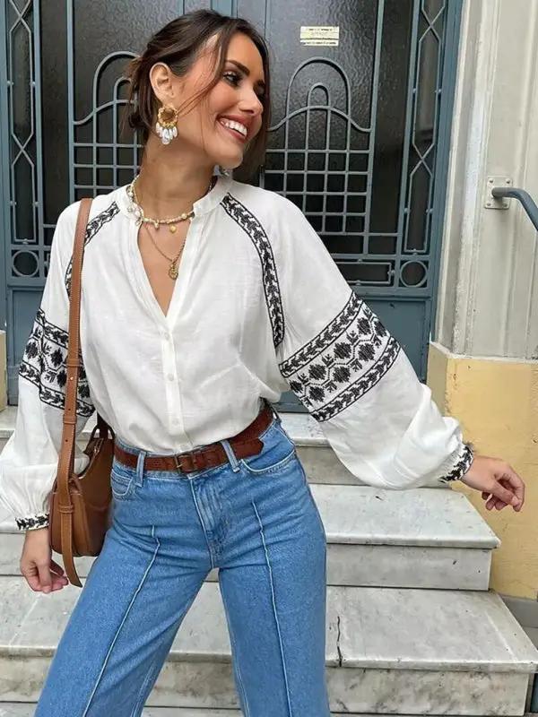 Woman wearing a cross-stitch contrasting shirt with jeans