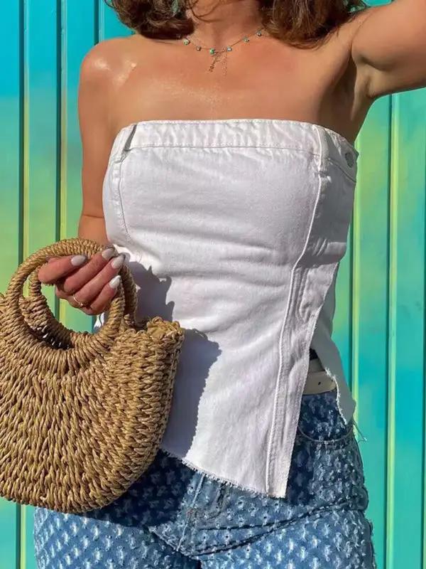Woman wearing white irregular tube top with woven bag