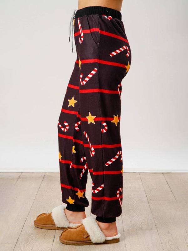 Side view of black Christmas pants with stars and candy canes