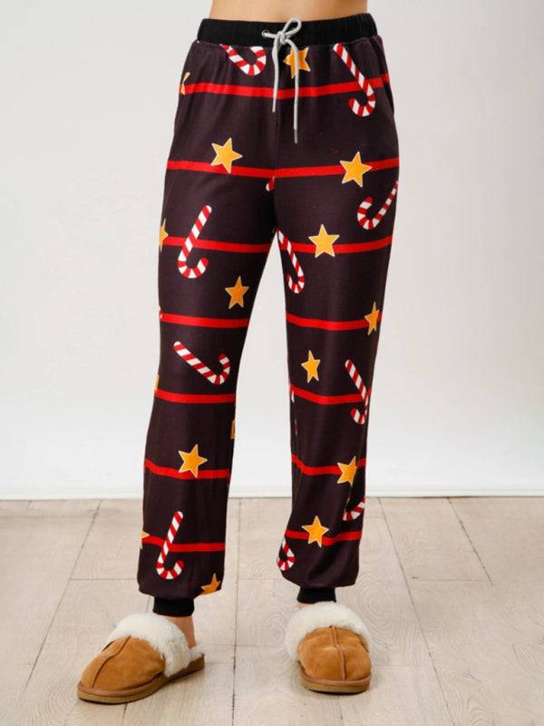 Front view of black Christmas pants with stars and candy canes