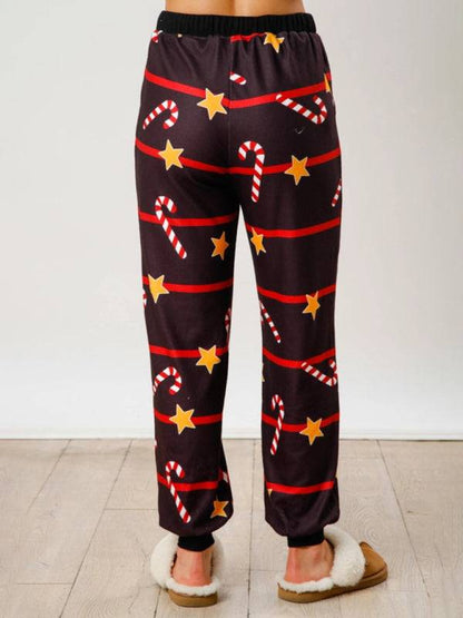 Back view of black Christmas pants with stars and candy canes