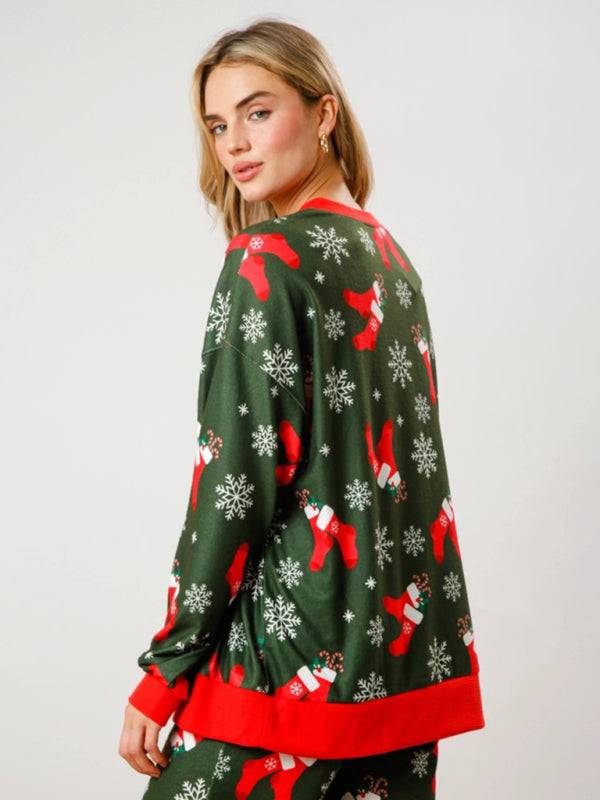 Back view of green Christmas top with stockings and snowflakes