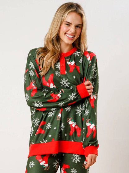 Green Christmas top with red stockings and snowflakes