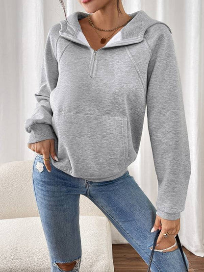 Gray hoodie styled with ripped jeans, front view.