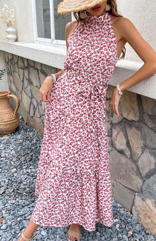 a woman in a floral dress and straw hat