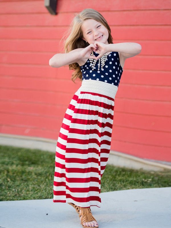 a little girl in a patriotic dress posing for a picture