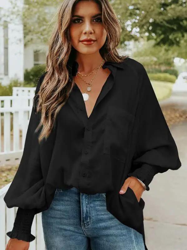 a woman wearing a black shirt and jeans