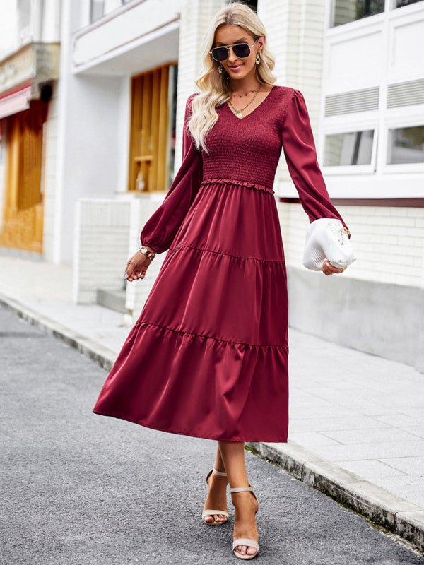 a woman in a red dress is walking down the street