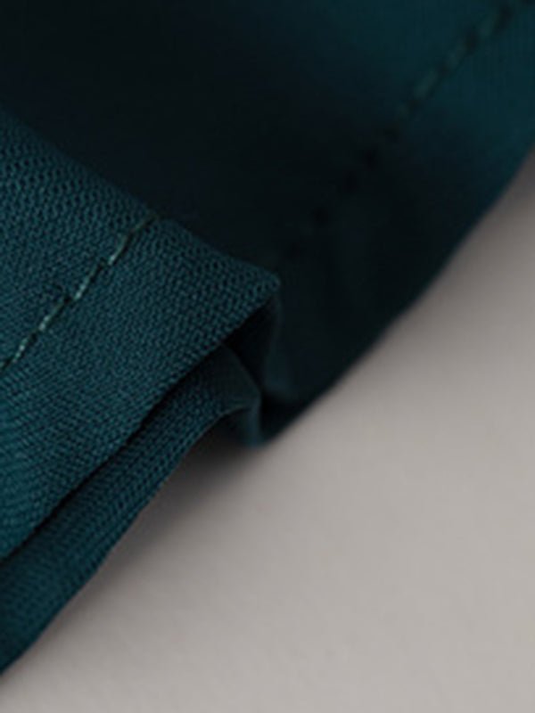 a close up of a pocket on a green shirt