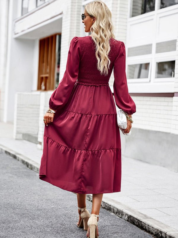 a woman in a red dress is walking down the street