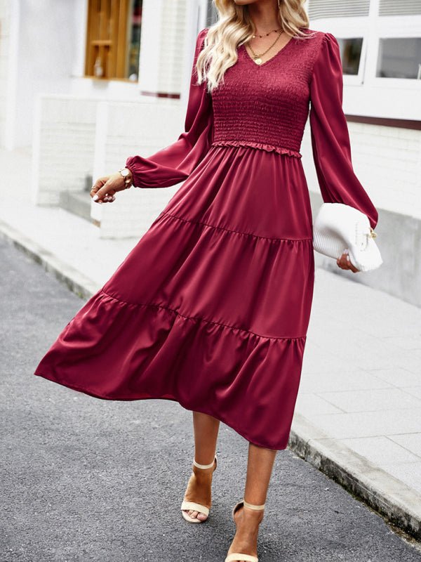 a woman in a red dress is walking down the street