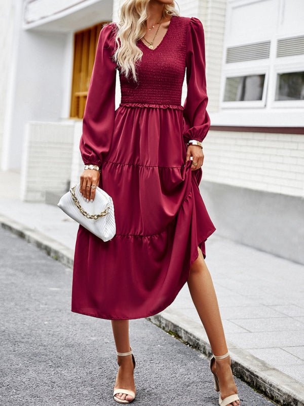 a woman in a red dress is walking down the street