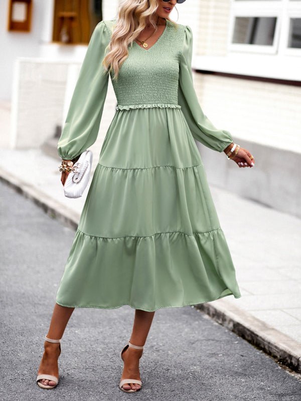 a woman wearing a green dress and hat