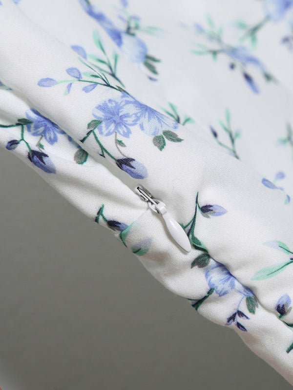 a close up of a white and blue flowered fabric