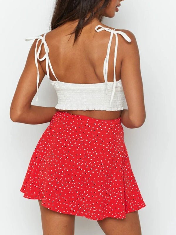 a woman wearing a red and white polka dot skirt