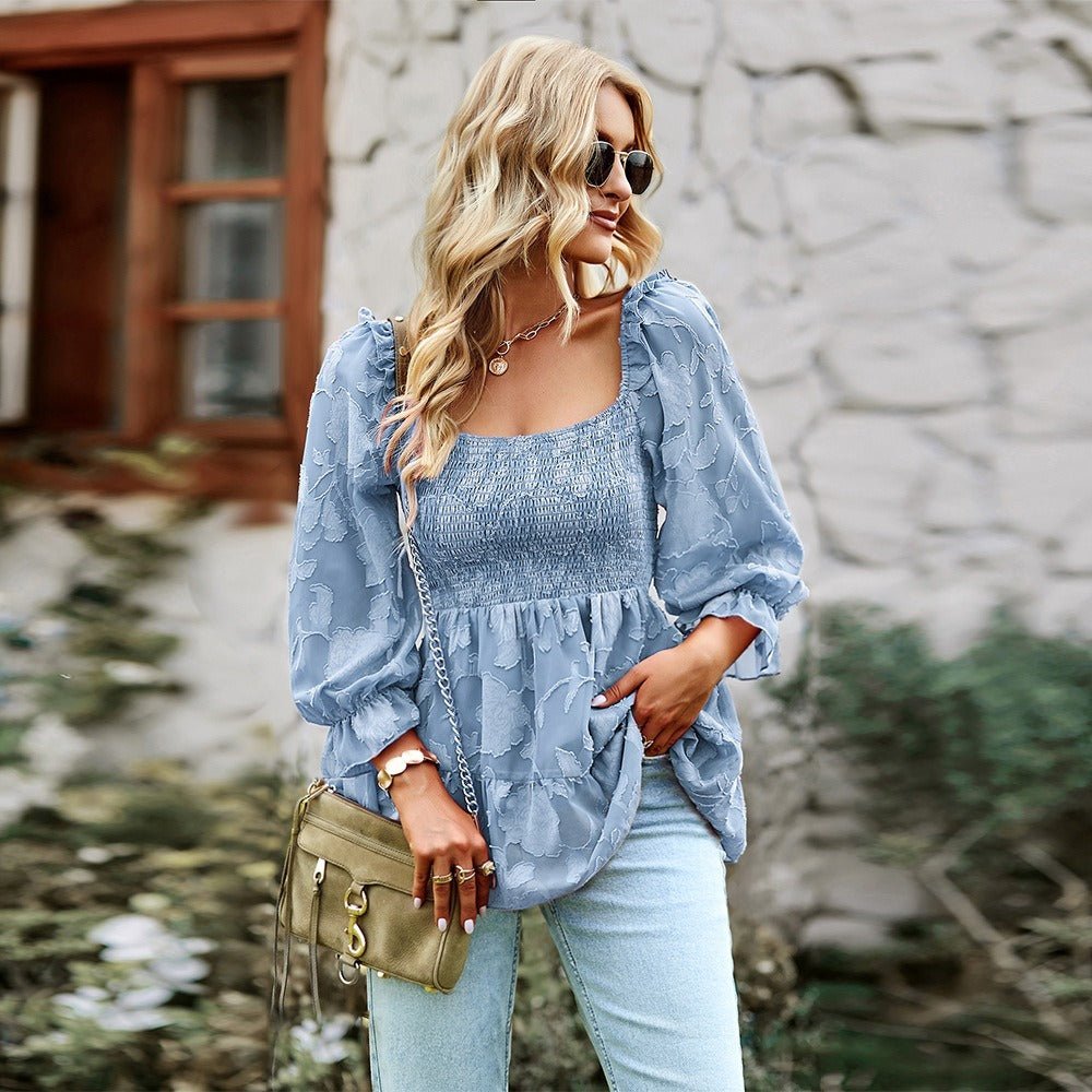 a woman wearing a blue blouse and jeans