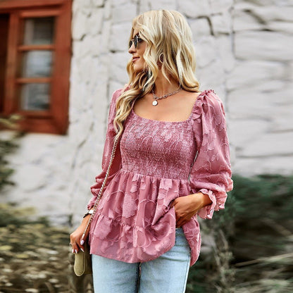 a woman wearing a pink blouse and jeans