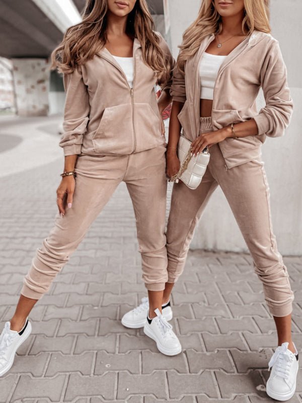 two women standing next to each other in matching outfits