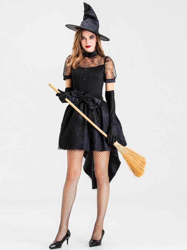 a woman in a witch costume holding a broom