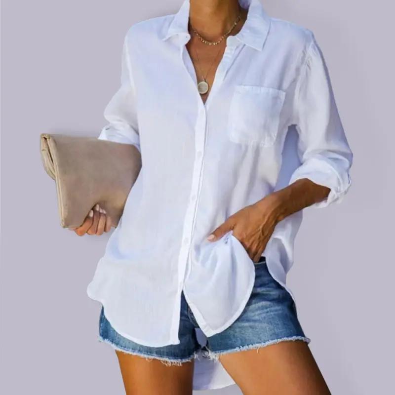 a woman wearing a white shirt and denim shorts