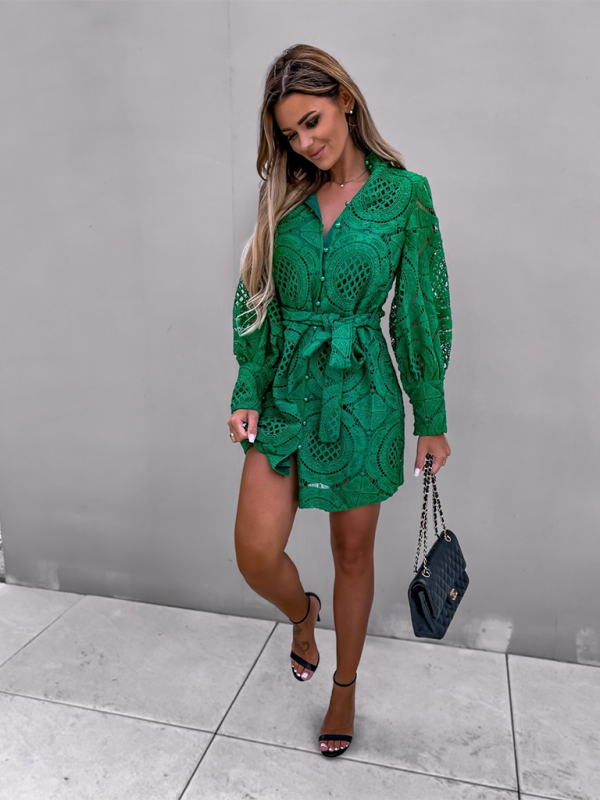 a woman wearing a green dress and heels