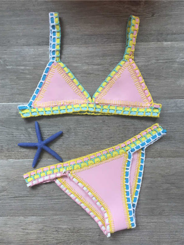 a bikini top and starfish on a wooden floor