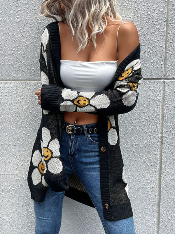 a woman wearing a white crop top and black cardigan
