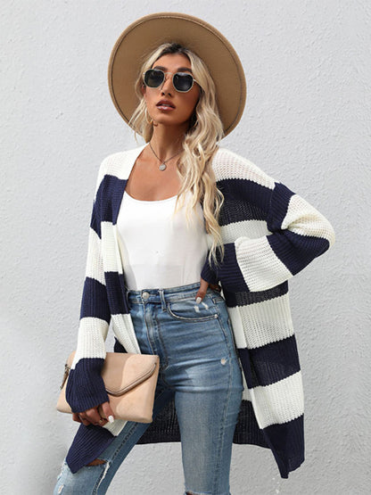 a woman wearing a striped cardigan sweater and jeans