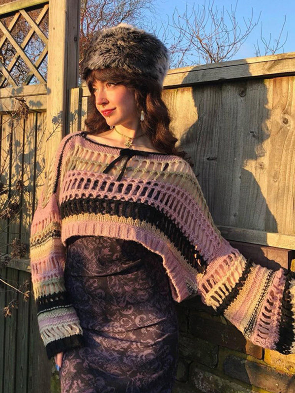 a woman standing next to a wooden fence