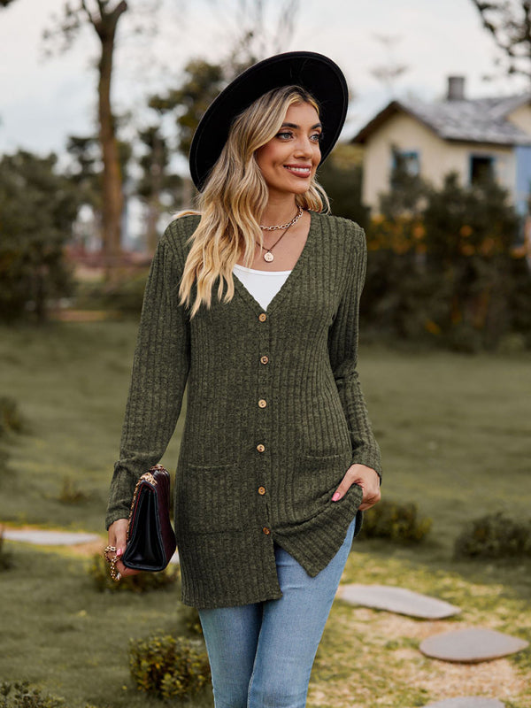 a woman wearing a green sweater and a black hat