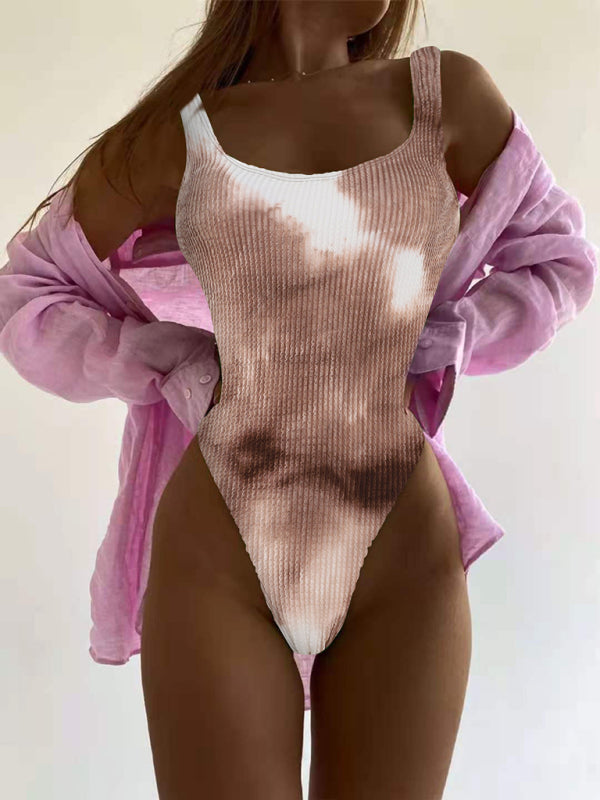 a woman in a pink and white one piece swimsuit