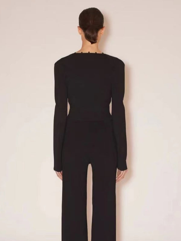 a woman in a black jumpsuit with a back cut out