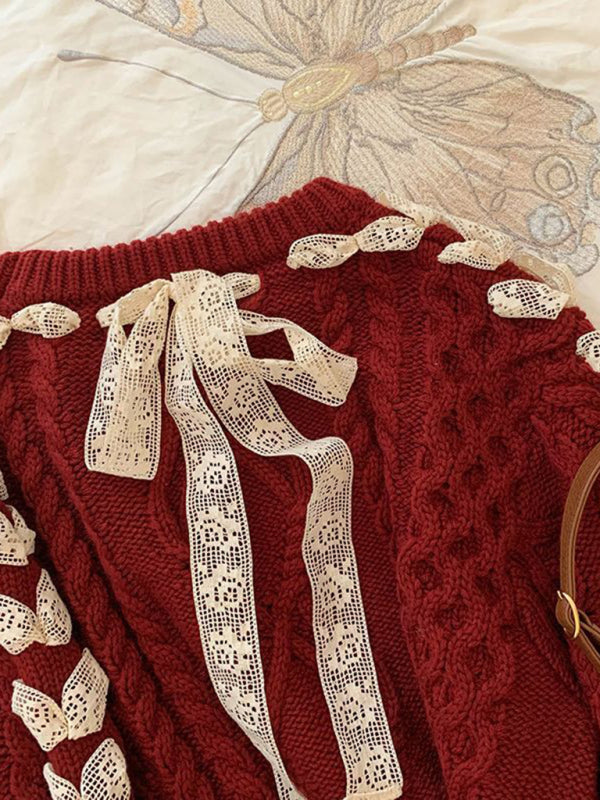 a close up of a sweater and a purse on a bed