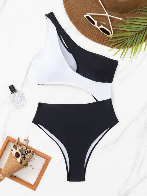 a black and white one piece swimsuit next to an ice cream cone