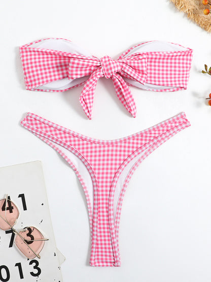 a pink and white checkered bikini with a bow tie