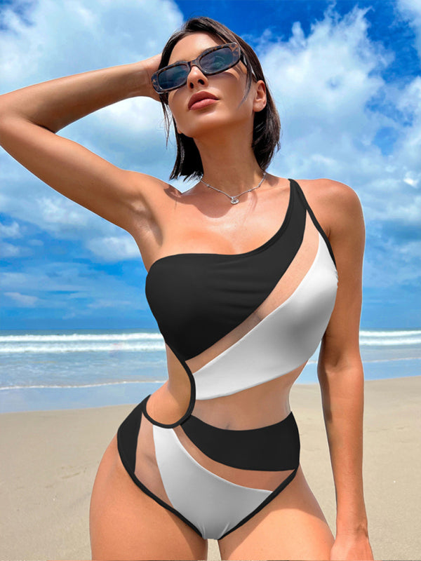 a woman in a black and white bikini on the beach
