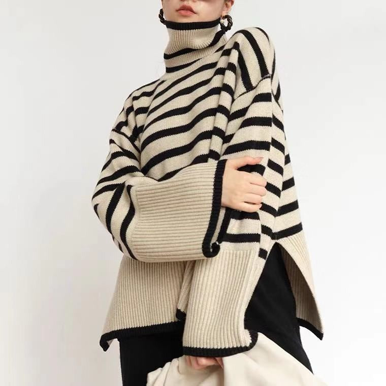 a woman wearing a black and white striped sweater