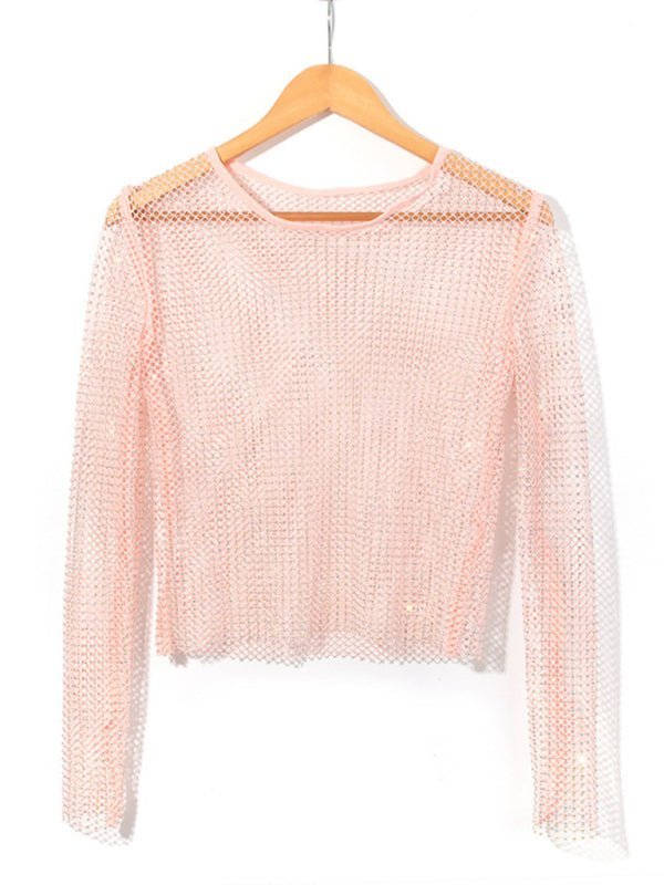 a pink sweater hanging on a wooden hanger