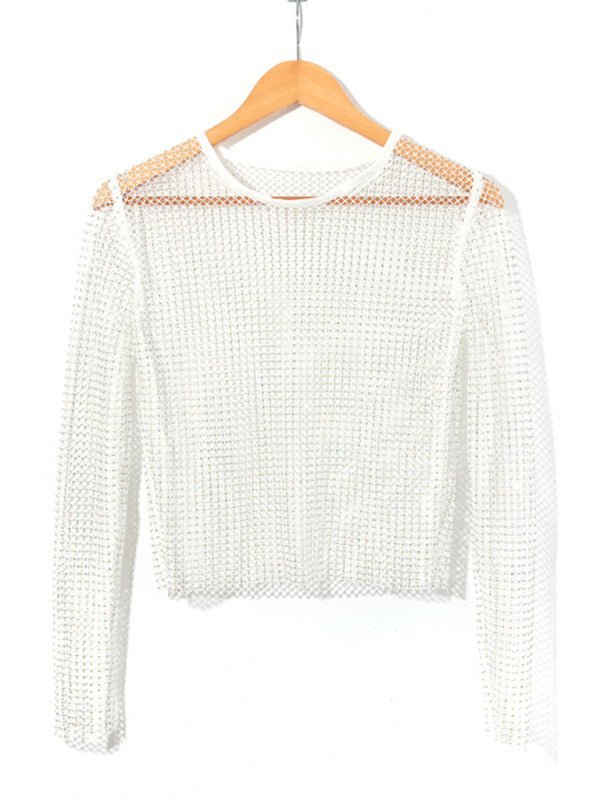 a white sweater hanging on a wooden hanger