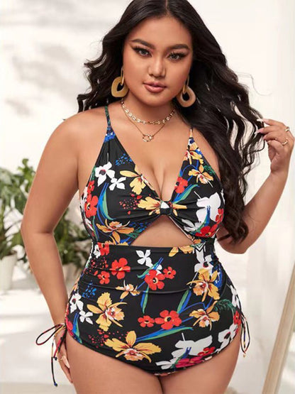 a woman in a floral print one piece swimsuit