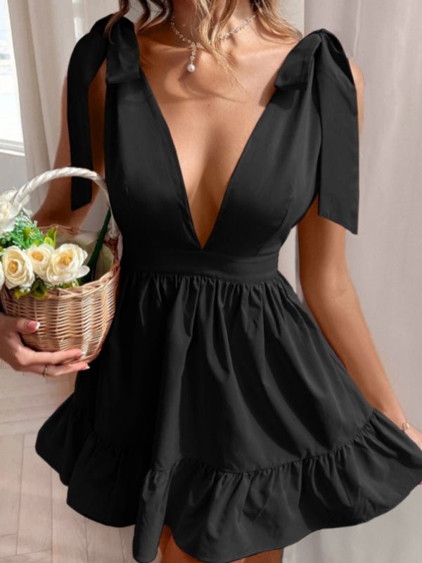 a woman in a black dress holding a basket of flowers